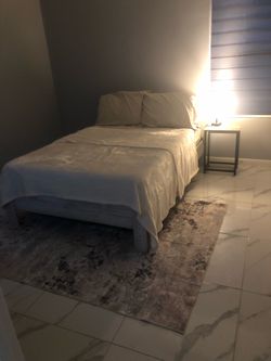 Full wood beige bed frame and 5x7 area rug