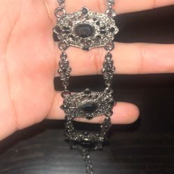 a vintage-style sterling silver and black onyx link bracelet, similar to estate jewelry findings. 