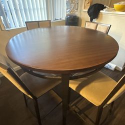 Round copper top dining room table set.