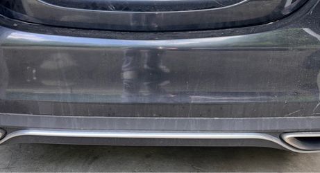 OEM Mercedes-Benz rear bumper cover with factory lower diffuser/exhaust trim. Removed from a Mercedes-Benz C300 W205.