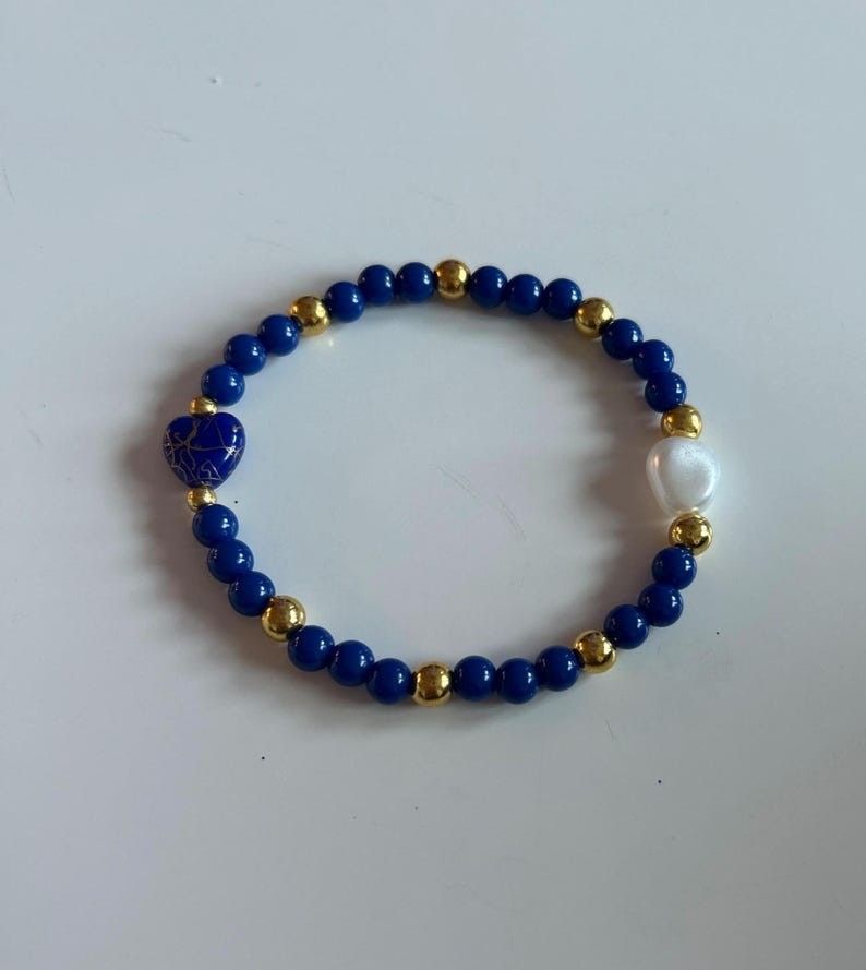 Elegant Handmade Blue Beaded Bracelet with Gold Accents and Glass Heart Charms