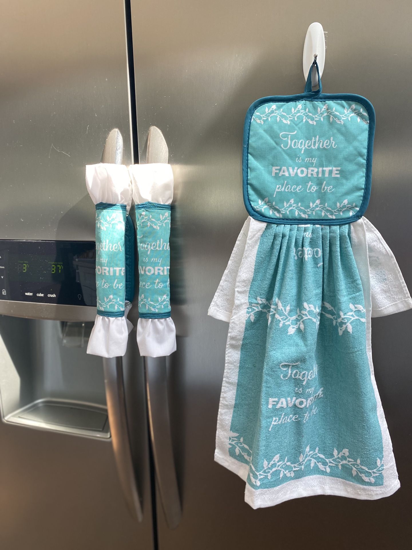 Kitchen towel with decorative pot holders.