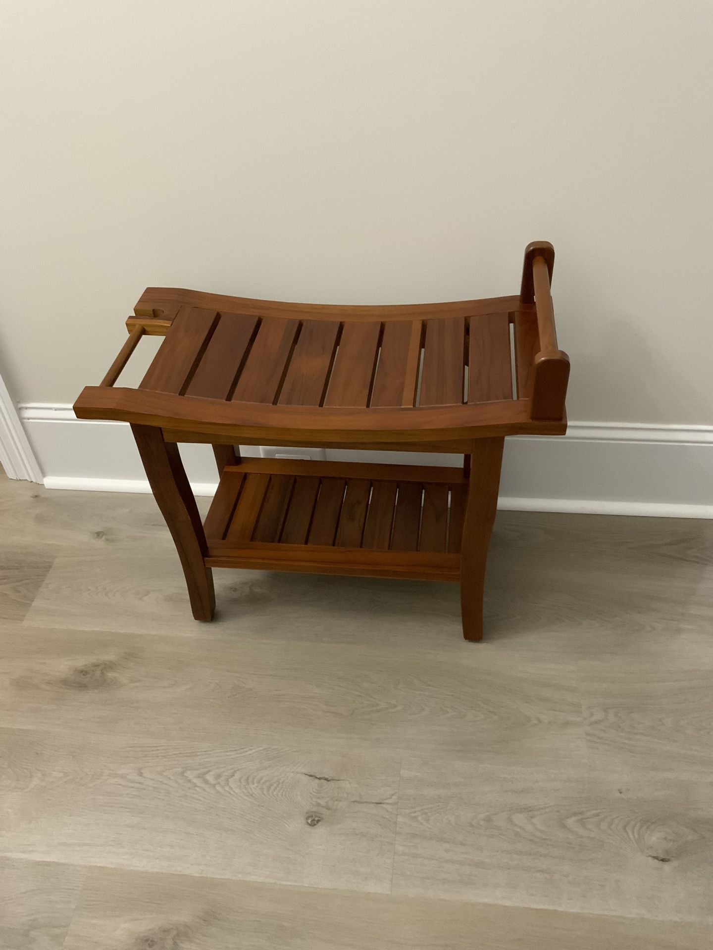 Teak Shower Bench with shelf. New. Never used. Levelers on the feet. Dimensions in the photos.