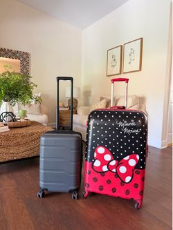 American Tourister 30” Disney suitcase and a carry on size luggage.