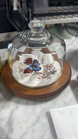Vintage glass dome with wood platter and butterfly ceramic