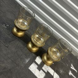 Elegant gold glasses with decorative design.