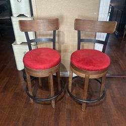 Beautiful pair of wood &metal counter height barstools :24” red microfiber seat cushions . Swivels . Very good condition