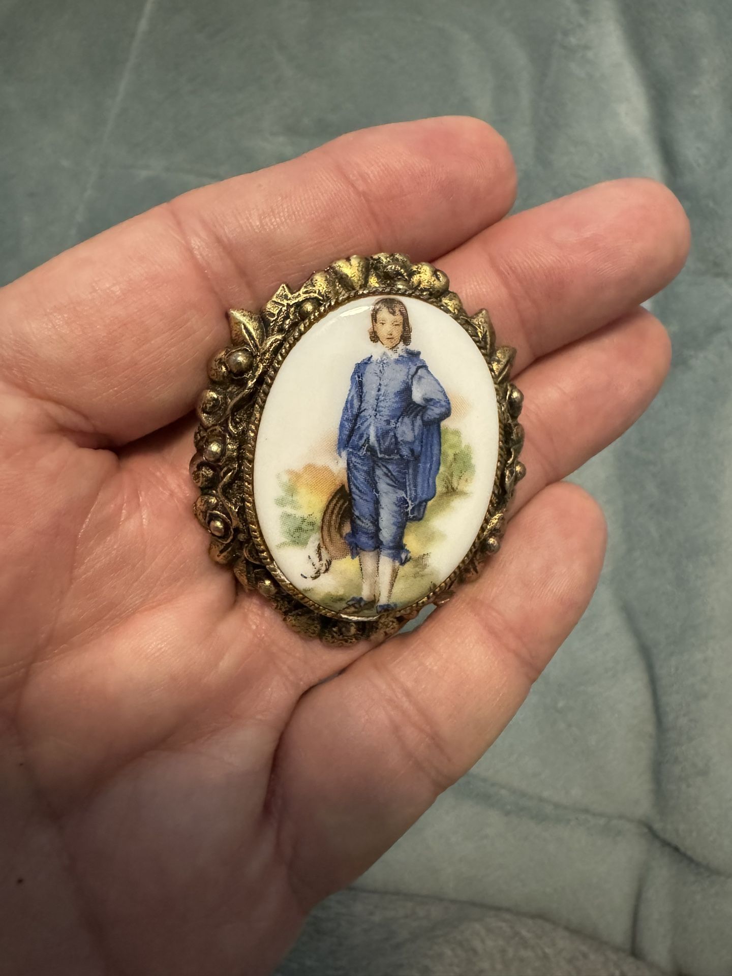 Antique brooch with a painted portrait in a decorative frame