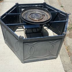 assembly and fire pan for an outdoor fire table or fire pit. It consists of a metal frame, a circular pan, and a circular gas burner ring. 