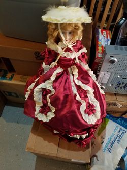 Beautiful antique doll in red dress