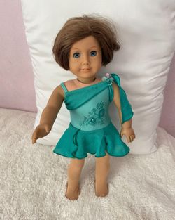 American Girl Doll Wearing Ice-Skating Dress And Tights And Star Shaped Earrings