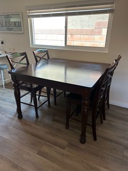 Brown wooden family table, comes with 6 chairs total( four shown in pic)