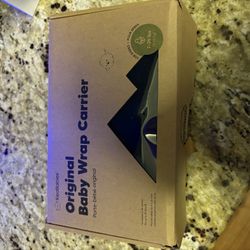 OPENED, NEVER USED BABY CARRIER WRAP. 