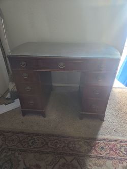 antique desk with a glass top