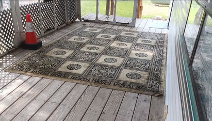 Large brown with black design rug for sale