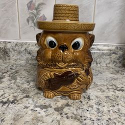 This Happy Guitar Carrying Hat Wearing Bear Cookie Jar