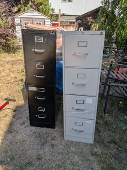 2  tall metal file cabinets