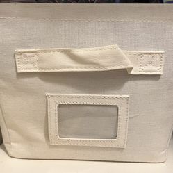 Two storage basket, tan and red. 9 1/2 inch wide, 13 inch, and 7 1/2 height