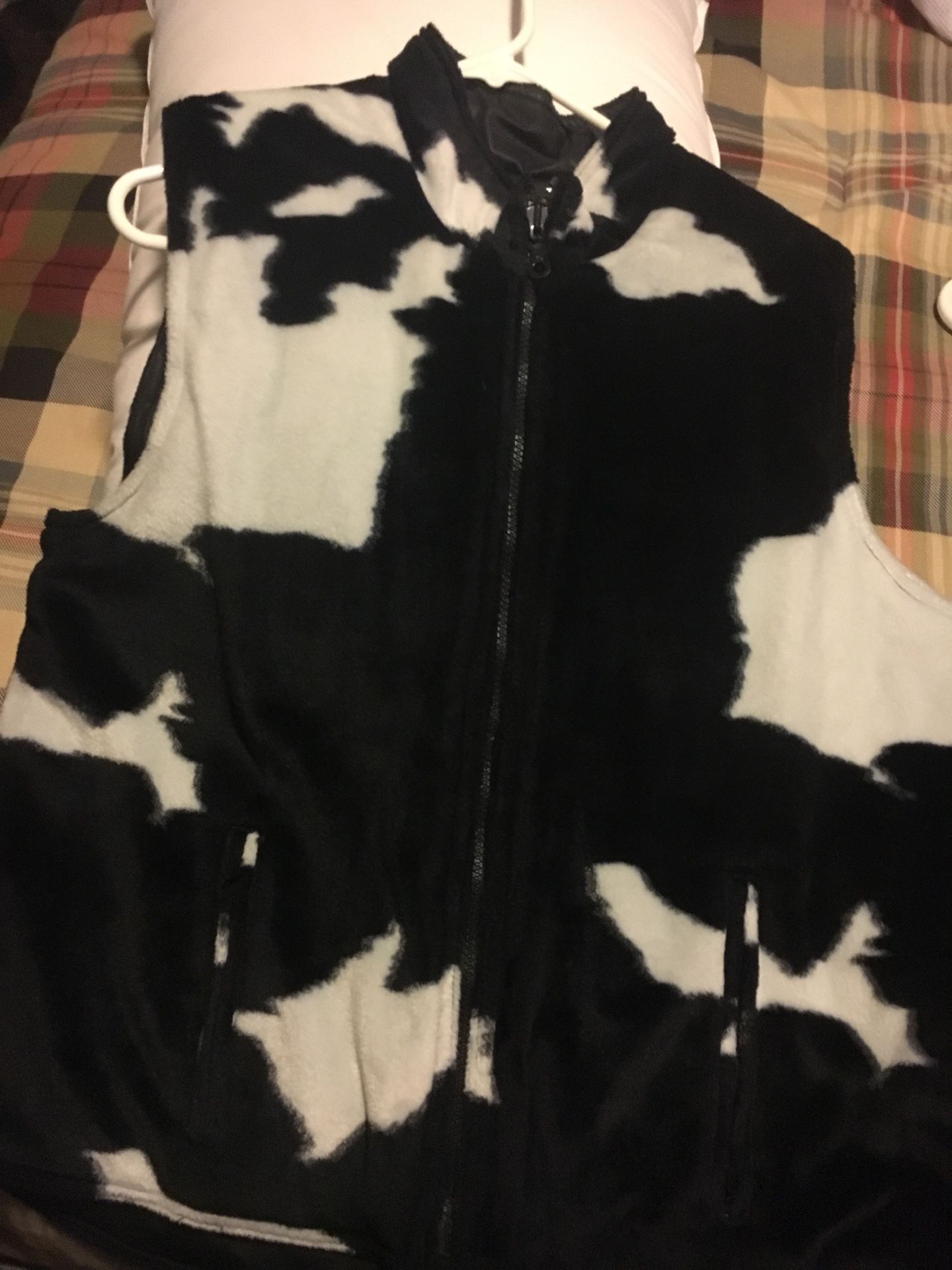 Reversible vest . Cow print fur / slick waterproof. Zip pockets on each side . Zip front .