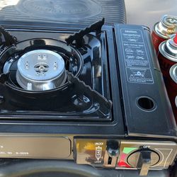 Portable butane cooker and 4 cans
