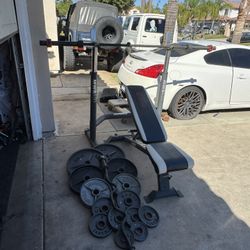 Bench press/squat rack with 7ft 45lbs bar plus 255lbs of Olympic weights and curl bar