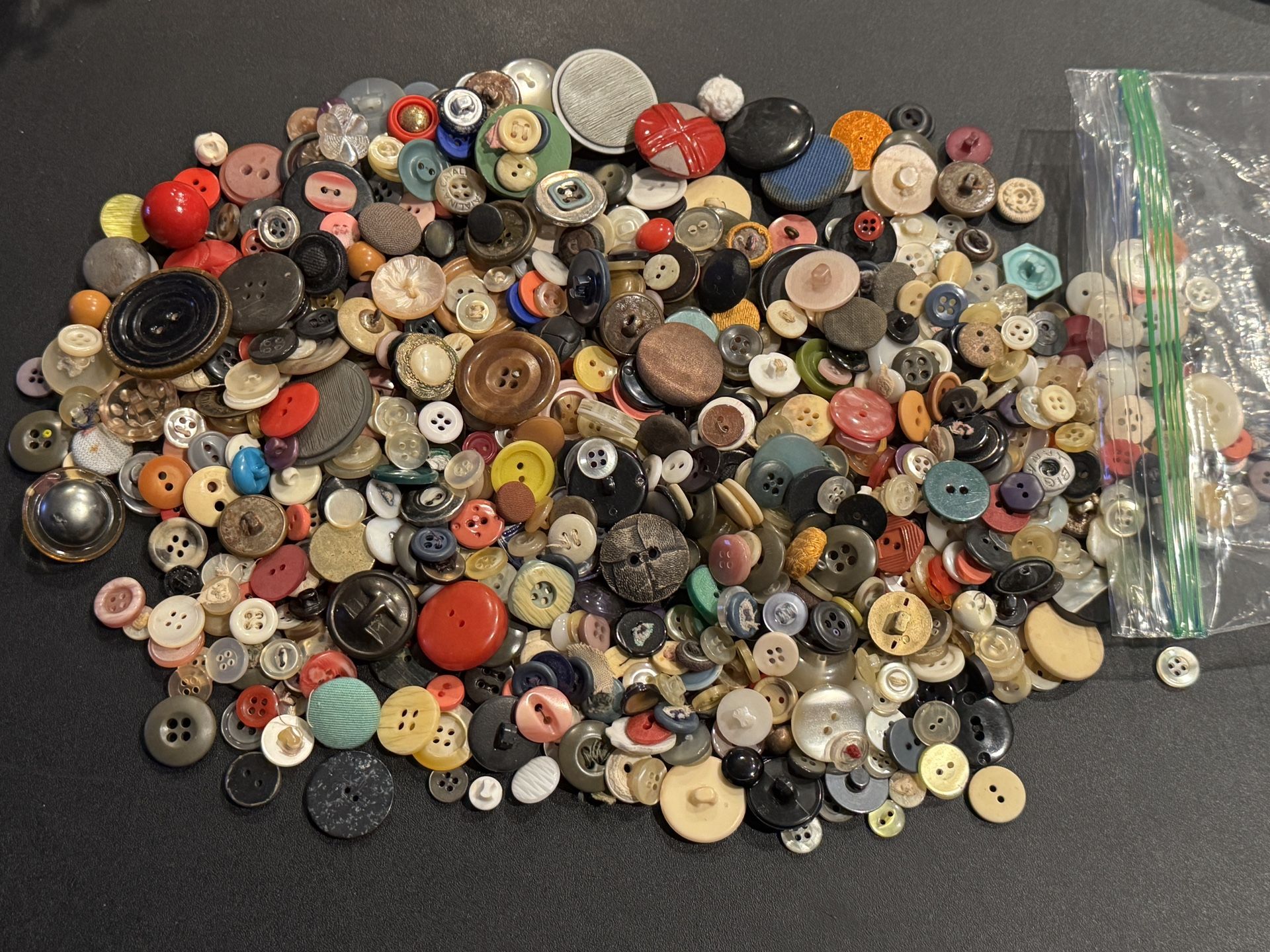 1 pound assortment of vintage buttons. Metal, Plastic, Fabric, MOP etc. Mixed lot of assorted buttons all different sizes and ages. Buttons are usedal