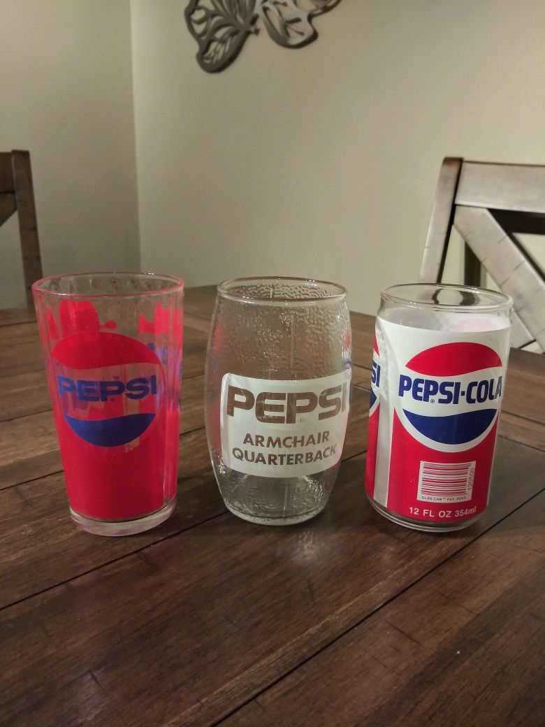 Collectible Pepsi glasses.  One a football, One a Pepsi can, and one a Prism.