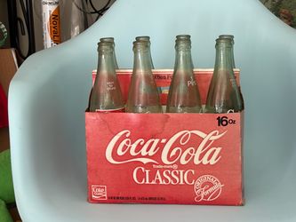 Collectible vintage Coke carton and bottles.