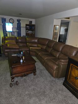 Entertainment center  and leather Sectionl/ let out bed and recliner.