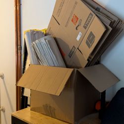 Moving boxes, moving paper, and a moving blanket