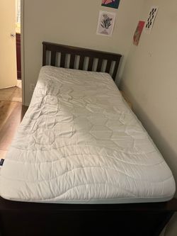 Dark wood twin bed frame and mattress