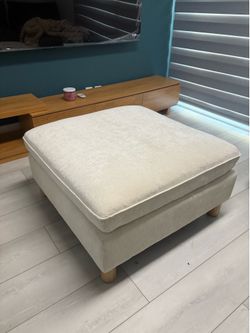Modern Cream Upholstered Ottoman – $50