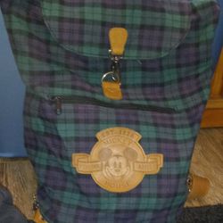 Great pre-owned condition From the Disney Store 90's green and blue plaid Brown leather strap and accents Mickey mouse Removable backpack straps Draws