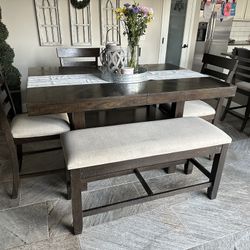 Gorgeous counter height, dinette set, four counter height, chairs, and one bench that opens to storage. Plenty of storage under the table as well.