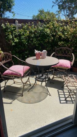 Wrought  iron patio set – two chairs, glass, top table and matching ottoman. $200.
