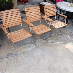 Three wood patio chairs