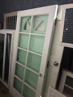 Wooden Front Door with glass design  36 inches wide  80 inches height  Door has two cracks on the top right corners does not affect  the door just thr