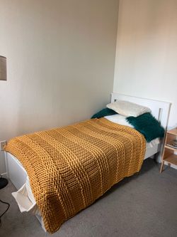 White IKEA Twin Bed Frame with a memory foam mattress