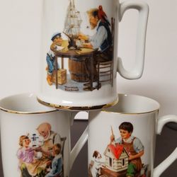 Collectibles, 1982, 1985, Norman Rockwell  of 3 cups, ounces 8, 10. Trimmend in gold, stamped seal of authenticity.
