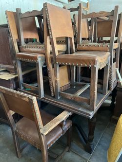 Antique wood table with sliding sides to seal 14 with 12 matching leather/wood chairs ( 3 need work)