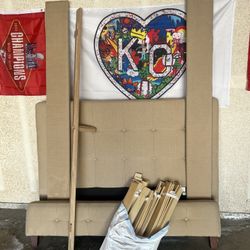 Beige upholstered queen, size bed