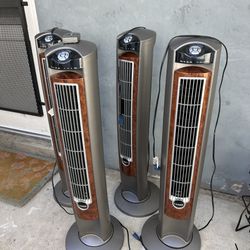 2 Oscillating Tower Fans With Remotes By Lasko