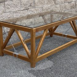 COFFEE CENTER TABLE W WOODEN LEGS & GLASS ON TOP - delivery is negotiable