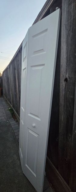 For sale: White hallow-Core bifold closet doors - Complete with the rails measurements: 80" x 30" 

White bifold closet doors are made of wood or comp