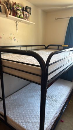 Selling a black bunk bed with mattresses in very good condition.