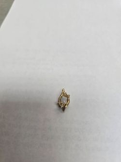 14k gold opal with four diamond chips pendant.