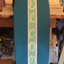 Solid wood welcome surfboard