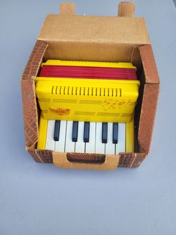 Emenee Toy Keyboard Accordion from around 1955, complete with its original textured cardboard carrying case vintage 1955