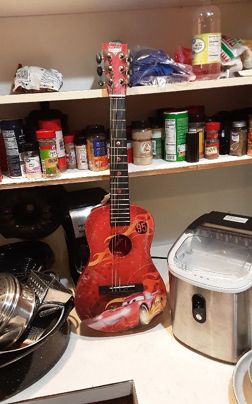 A Little  Kid Cars Disney Guitar