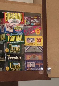 12 sets/boxes of cards. Hockey baseball football basketball. Most in rappers. Never opened. Factory case.